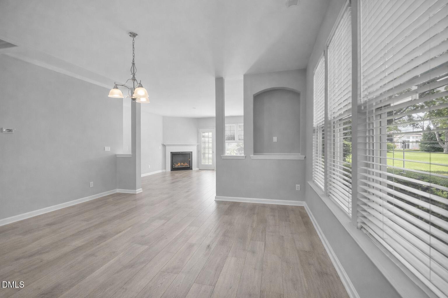 6626 Clarksburg Place Raleigh, NC 27616 - Photo 4 of 25 a view of a room with wooden floor staircase and a kitchen