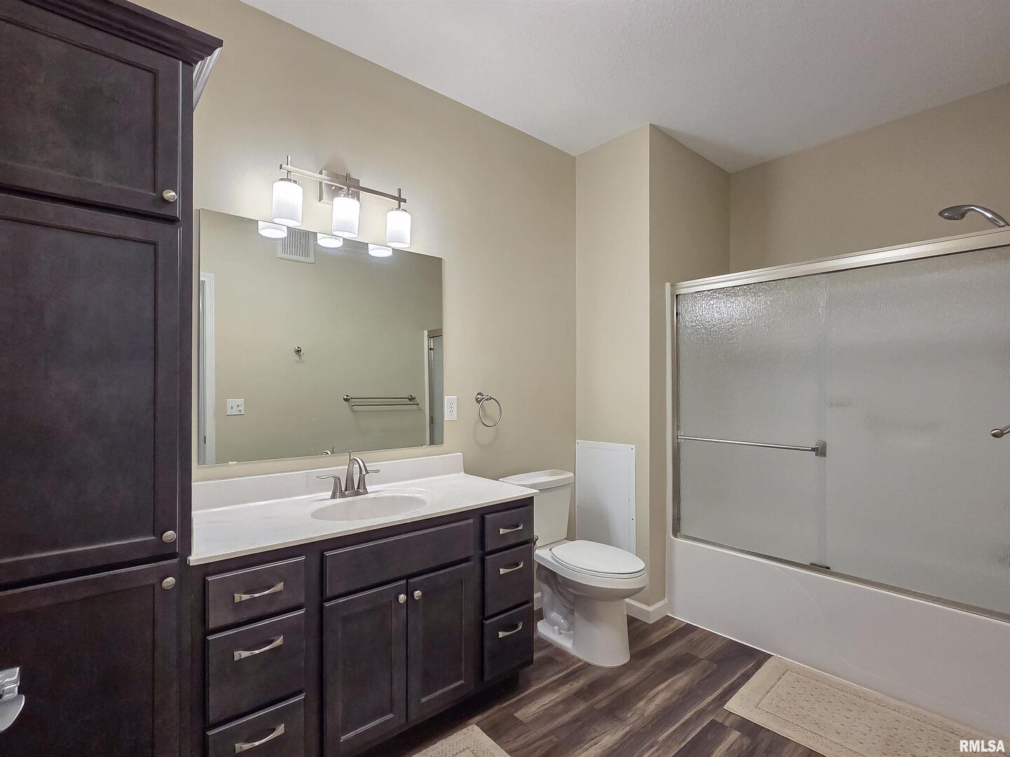 2592 Middle Road, Unit 313 Bettendorf, IA 52722 - Photo 33 of 52 a bathroom with a sink a toilet and shower