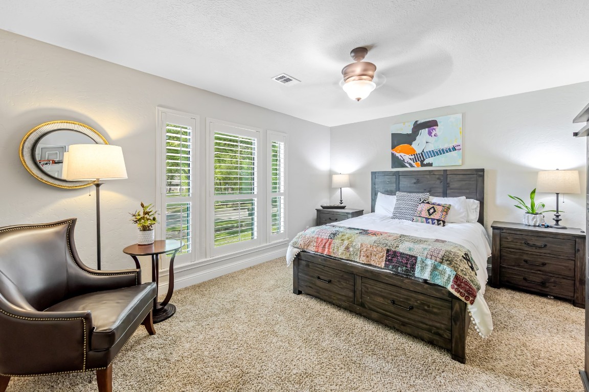 13303 Lost Creek Road Tomball, TX 77375 - Photo 28 of 50 a bedroom with a bed a couch and a large window
