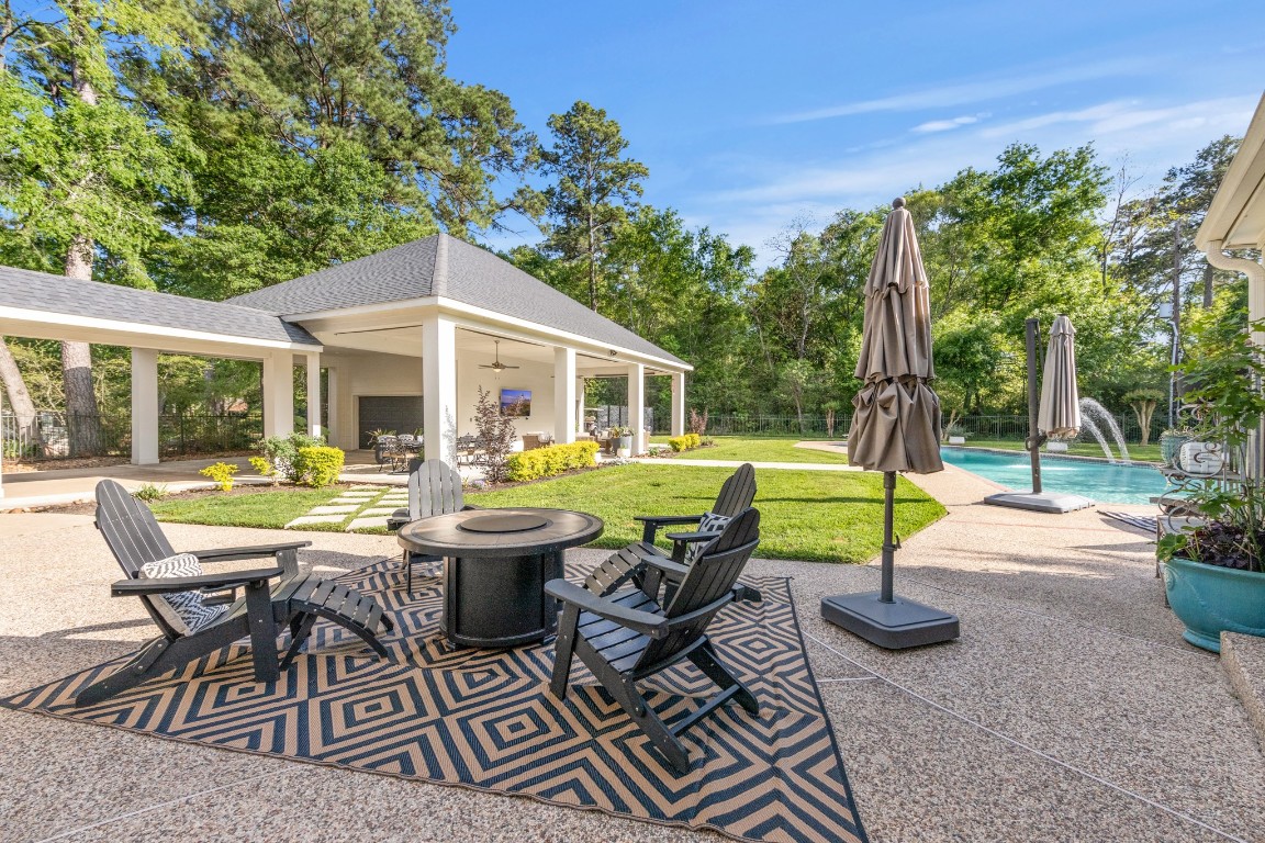 13303 Lost Creek Road Tomball, TX 77375 - Photo 50 of 50 a view of a patio with table and chairs potted plants and palm tree