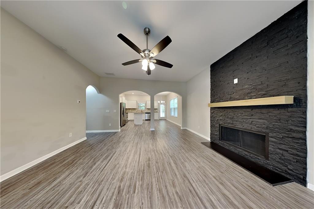 288 Stable View Loop Dallas, GA 30132 - Photo 2 of 19 a living room with a fireplace furniture and a wooden floor