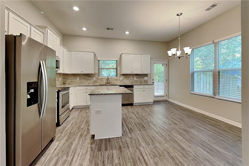 288 Stable View Loop Dallas, GA 30132 - Photo 4 of 19 a kitchen with stainless steel appliances a refrigerator sink and cabinets