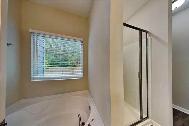 a bathroom with a bathtub and a shower