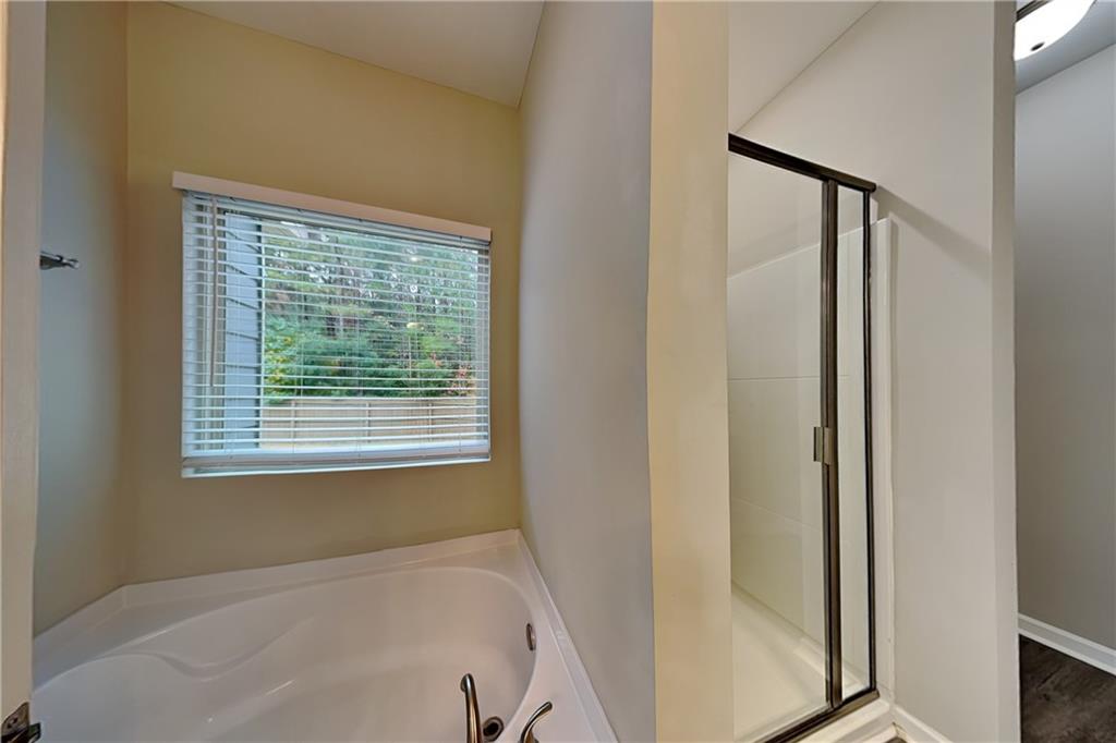 288 Stable View Loop Dallas, GA 30132 - Photo 8 of 19 a bathroom with a bathtub and a shower