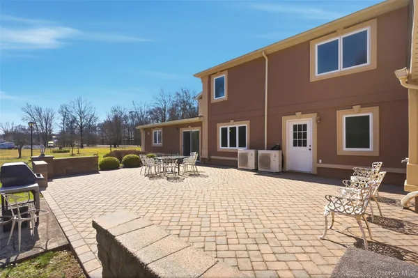 a view of a patio with dining table and chairs with wooden floor and fence