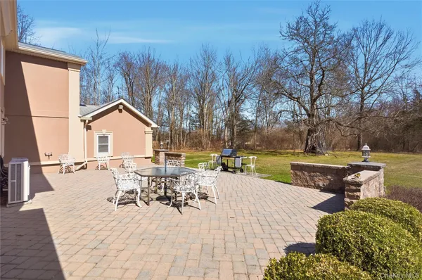 a view of a house with yard and sitting area