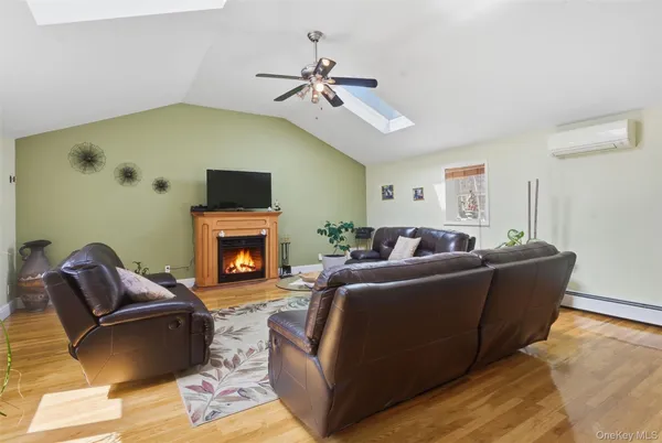 a living room with furniture a fireplace and a flat screen tv