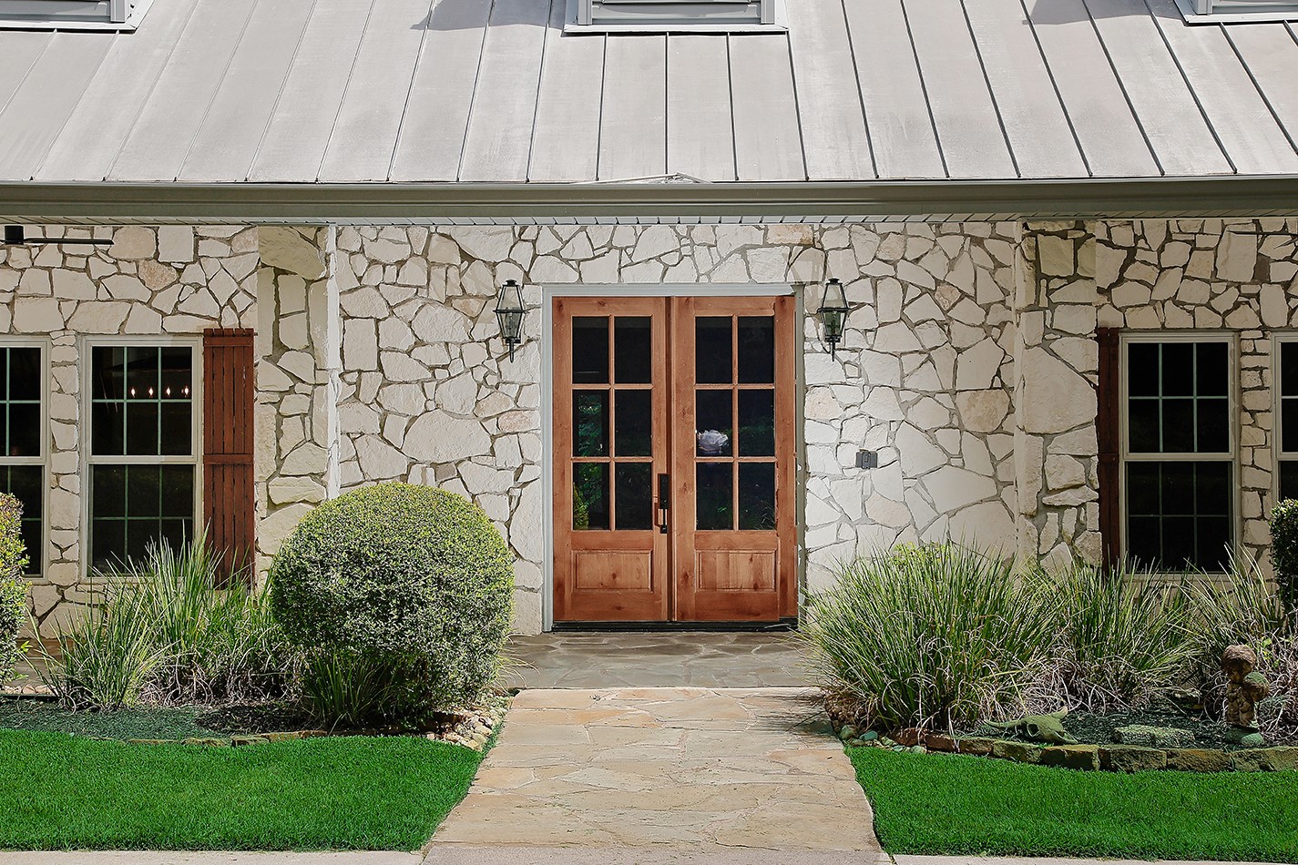 26442 McDonald Road Spring, TX 77380 - Photo 7 of 50 The gorgeous double doors, new lanterns and custom shutters look exceptional against light stone lending to the welcoming atmosphere.