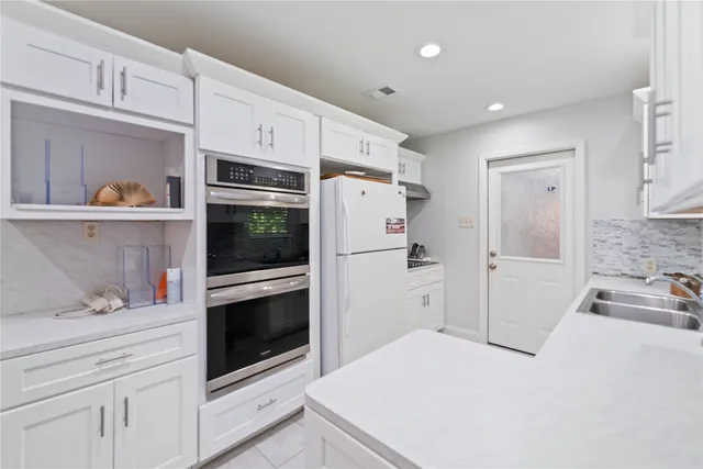 a kitchen with stainless steel appliances a refrigerator sink and cabinets