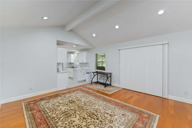 a living room with a rug and a table