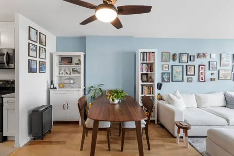 a living room with furniture and a bookshelf