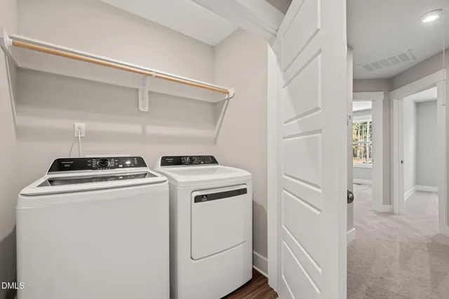 a view of washer and dryer with kitchen in the background