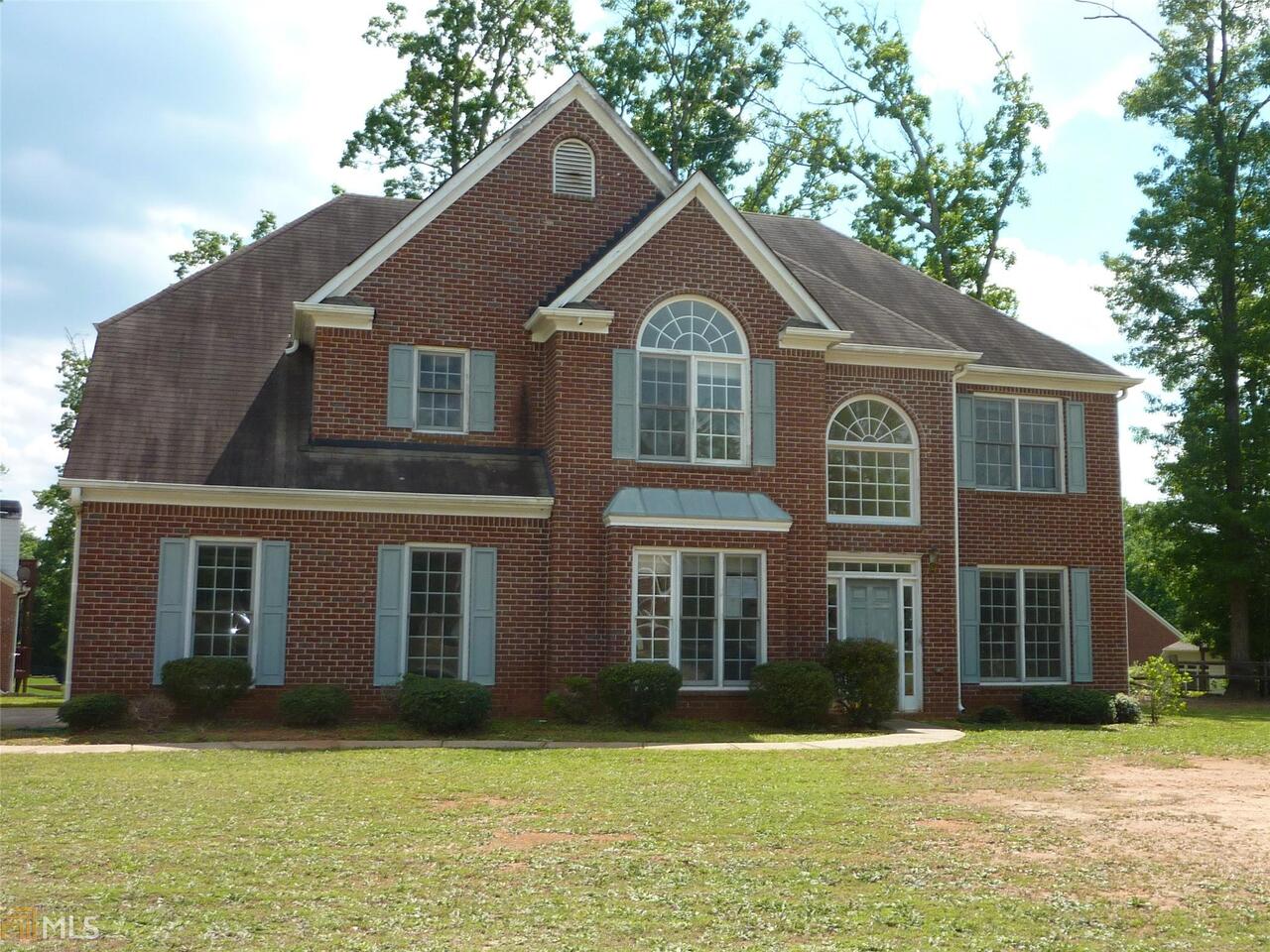 1802 Phillips Court Conyers, GA 30094 - Photo 1 of 1 a front view of a house with a yard