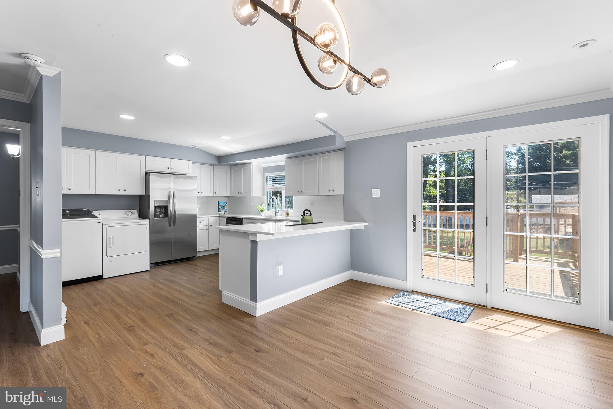343 Sugartown Road, Unit B Wayne, PA 19087 - Photo 14 of 14 a view of a kitchen with wooden floor and electronic appliances