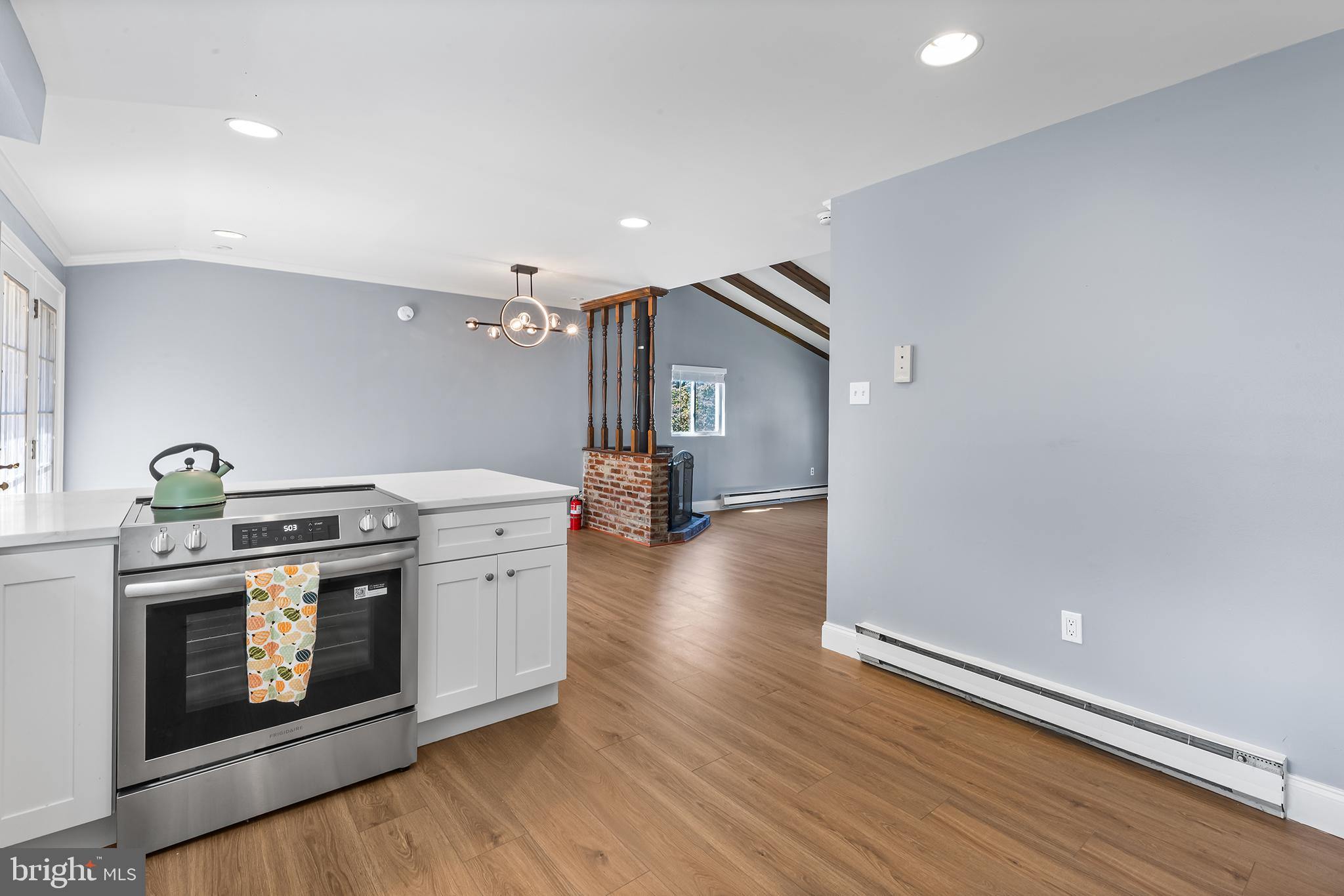 343 Sugartown Road, Unit B Wayne, PA 19087 - Photo 4 of 14 a kitchen with a stove and wooden floor