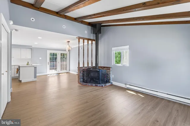 a kitchen with a stove and wooden floor