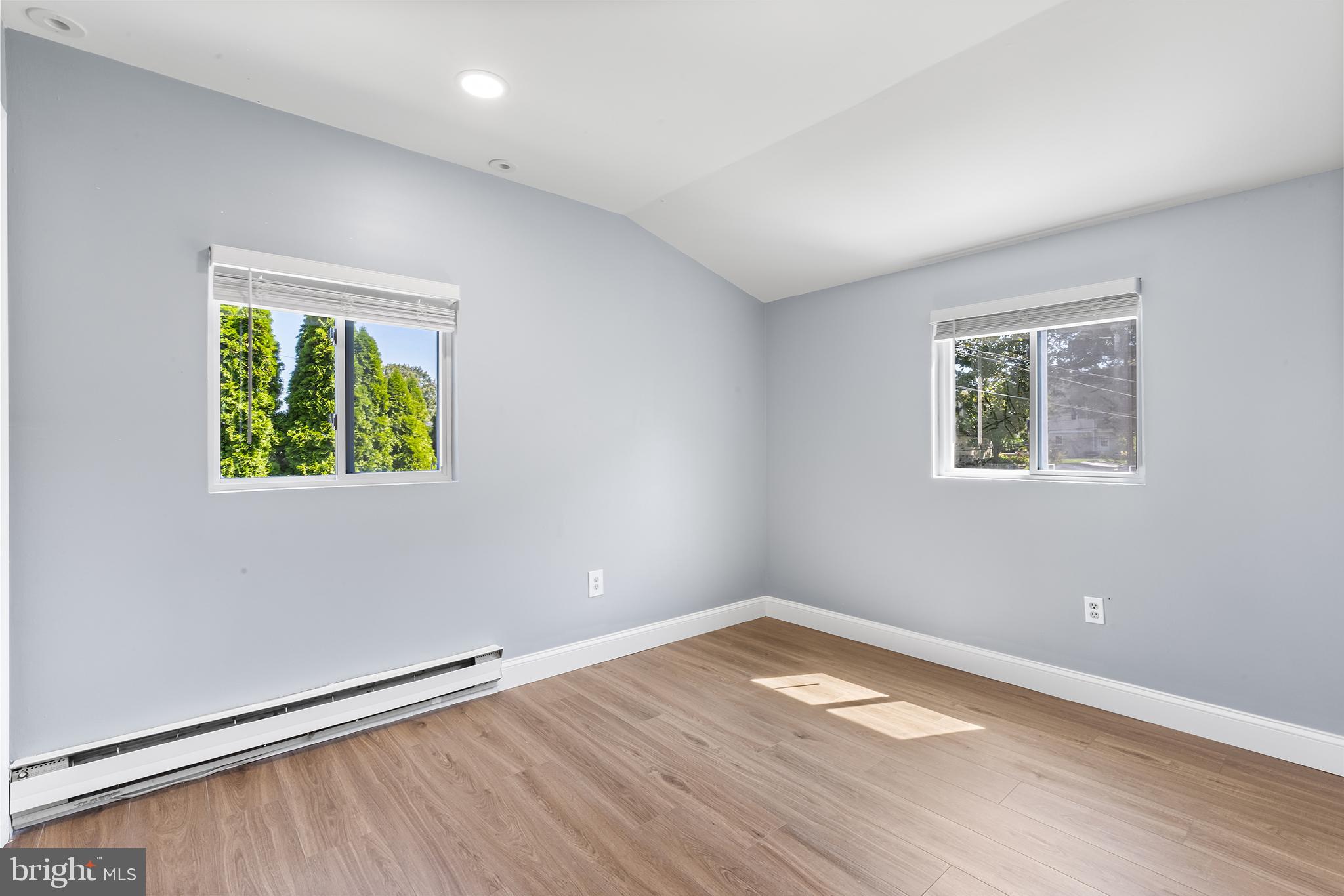 343 Sugartown Road, Unit B Wayne, PA 19087 - Photo 7 of 14 wooden floor in an empty room with a window