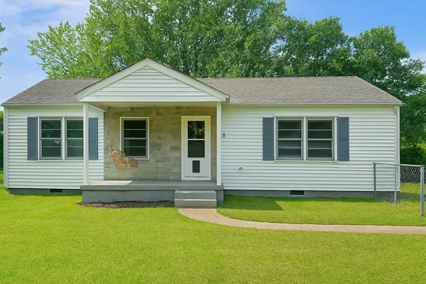 a front view of a house with a yard