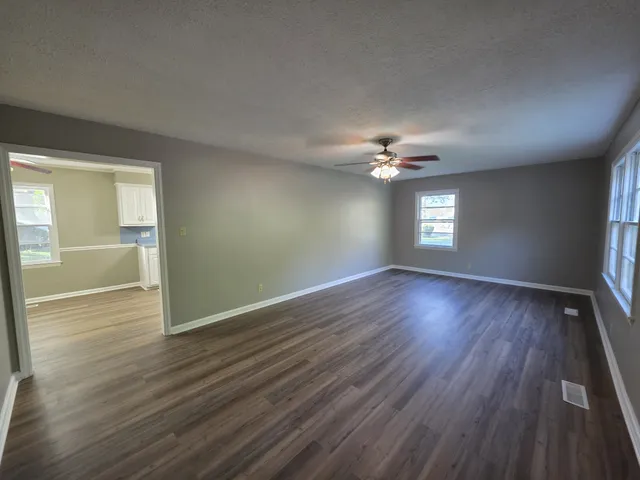 a view of a livingroom with wooden floor and a window
