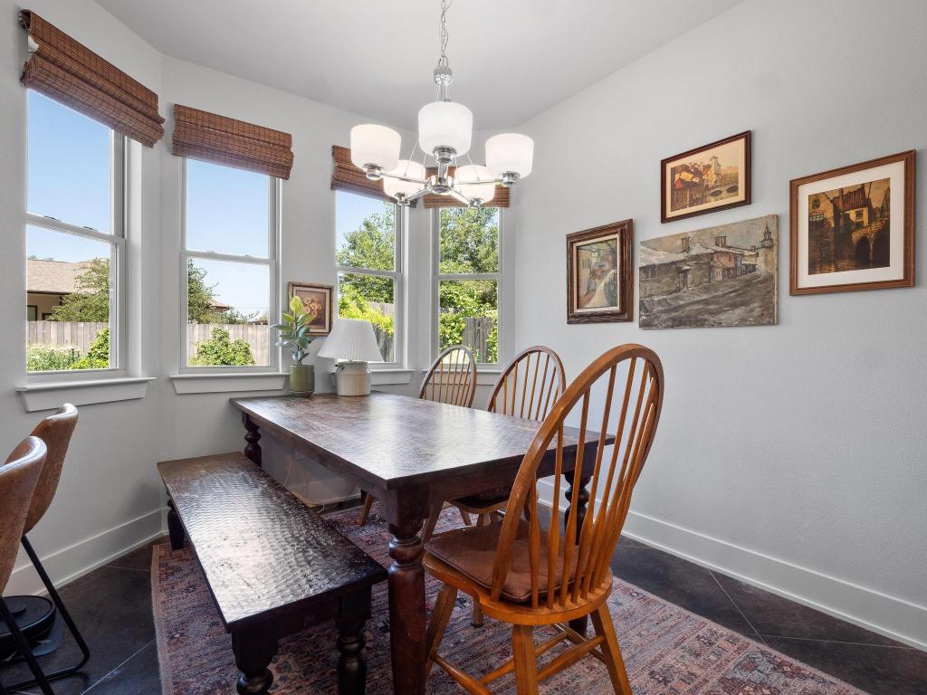 10103 Twin Lake Loop Dripping Springs, TX 78620 - Photo 18 of 32 Dining area featuring baseboards, a chandelier, and dark tile patterned floors
