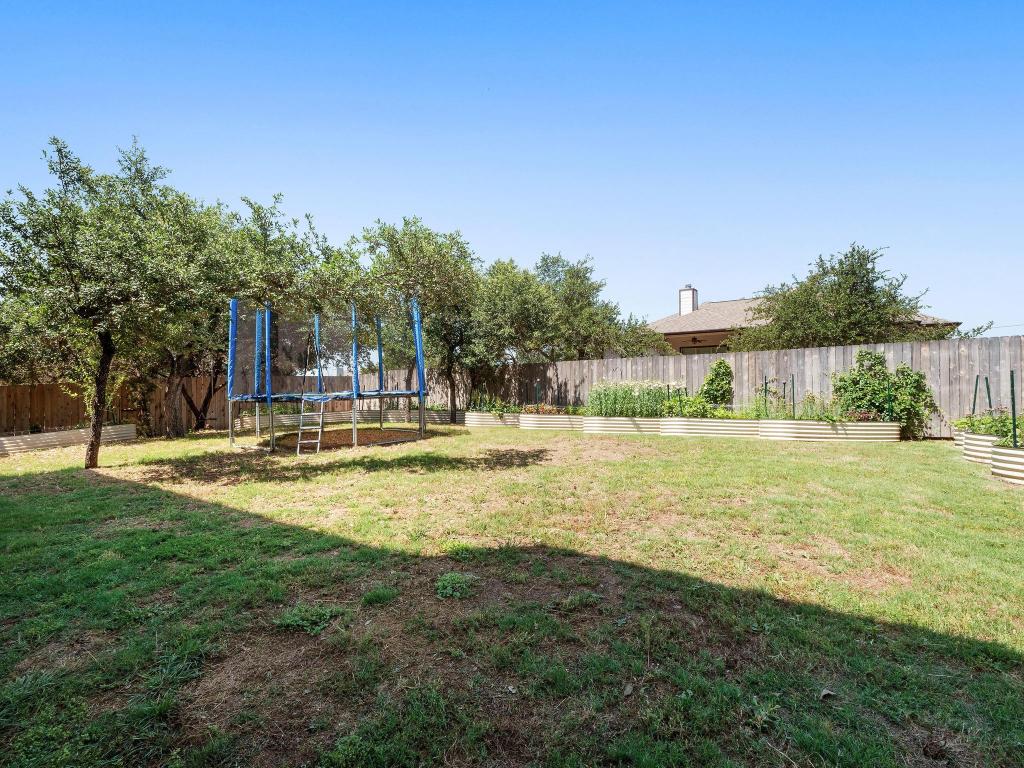 10103 Twin Lake Loop Dripping Springs, TX 78620 - Photo 30 of 32 View of yard with a trampoline