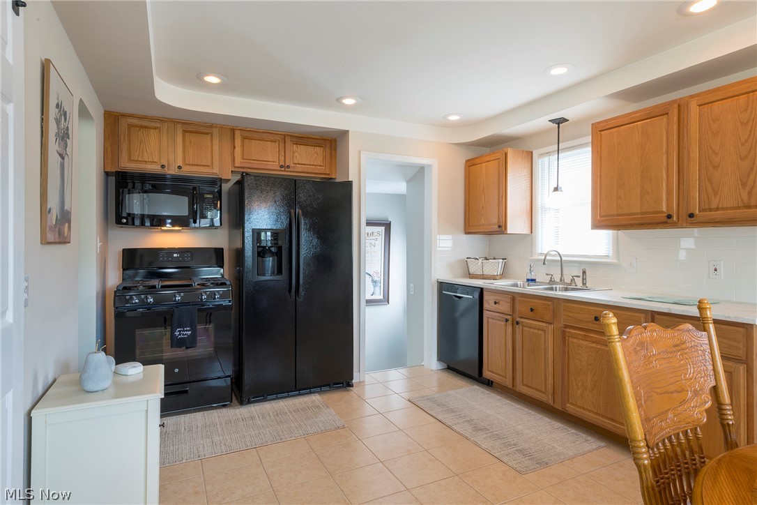 13175 McCracken Road Cleveland, OH 44125 - Photo 9 of 48 Kitchen featuring sink, pendant lighting, light tile floors, and black appliances