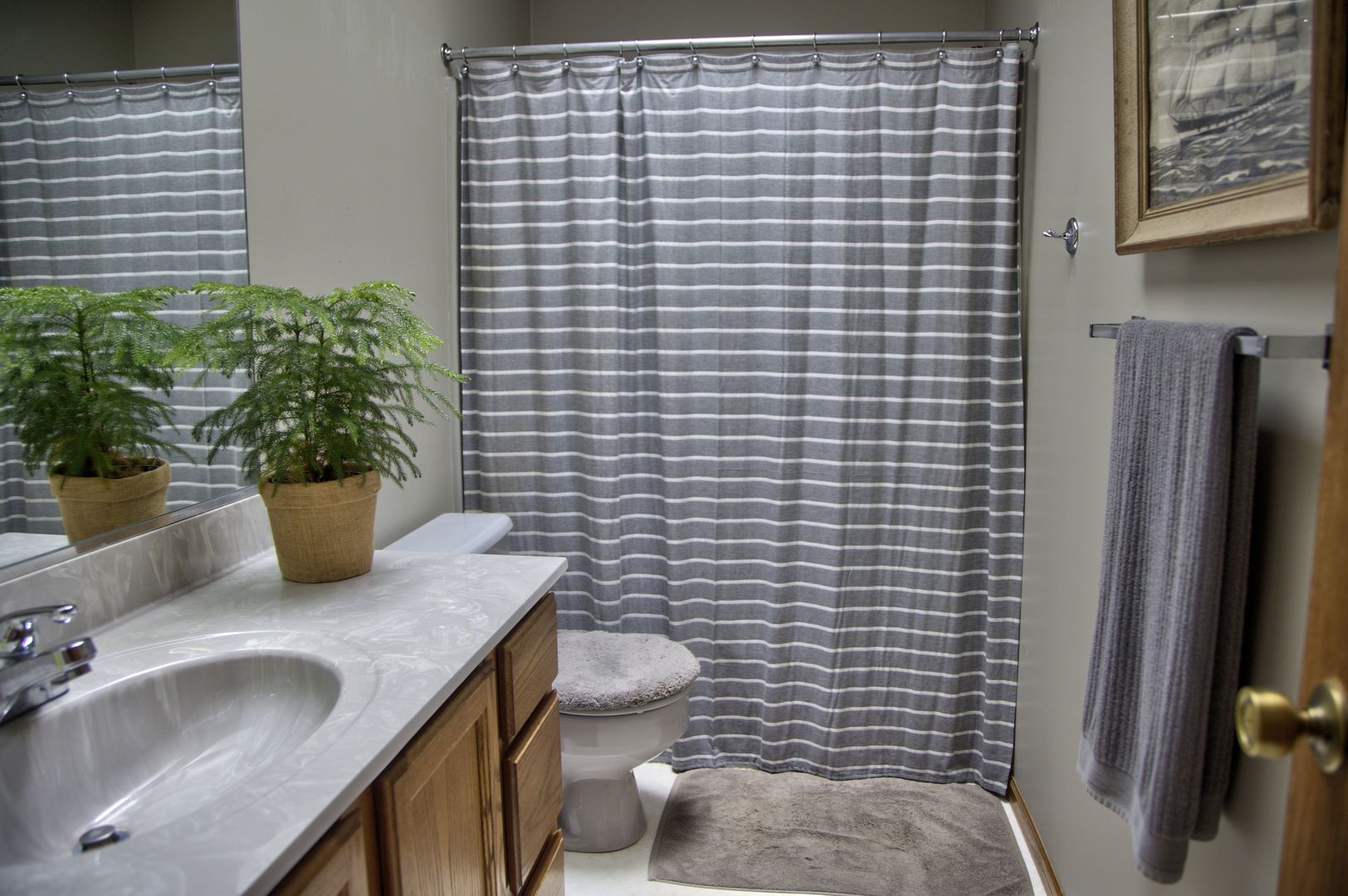 1311 Sunset Terrace Rochelle, IL 61068 - Photo 18 of 20 a bathroom with a granite countertop sink and a mirror