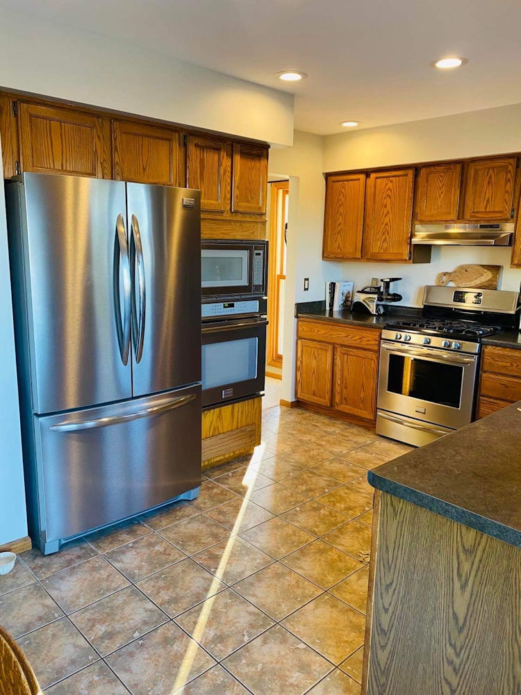 1311 Sunset Terrace Rochelle, IL 61068 - Photo 7 of 20 a kitchen with stainless steel appliances granite countertop a refrigerator a stove and a sink
