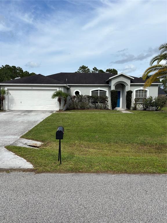 15 Zorach Place Palm Coast, FL 32164 - Photo 1 of 17 a front view of a house with garden