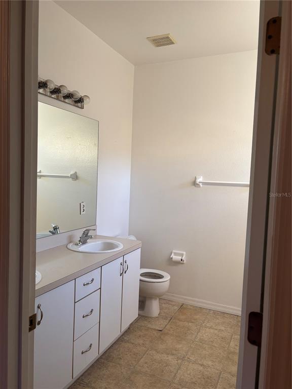 15 Zorach Place Palm Coast, FL 32164 - Photo 14 of 17 a bathroom with a granite countertop sink toilet and shower