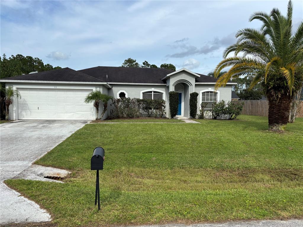 15 Zorach Place Palm Coast, FL 32164 - Photo 2 of 17 a front view of a house with a yard and garage