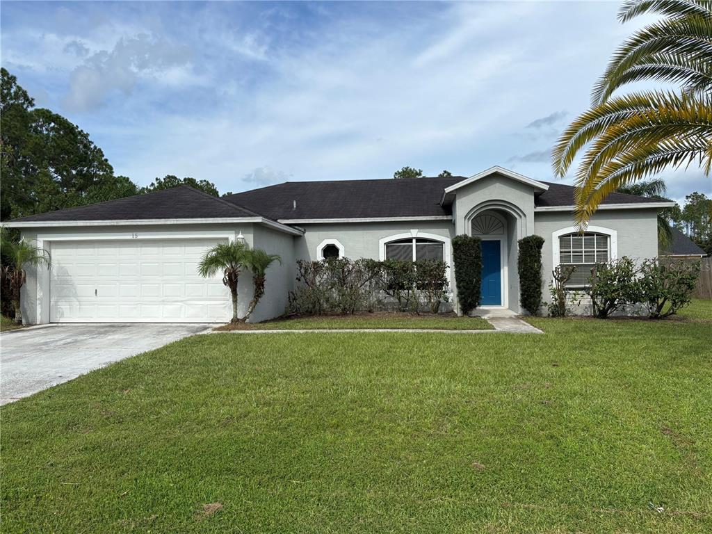 15 Zorach Place Palm Coast, FL 32164 - Photo 3 of 17 a front view of a house with garden