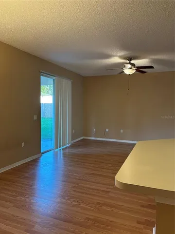 a view of an empty room with wooden floor