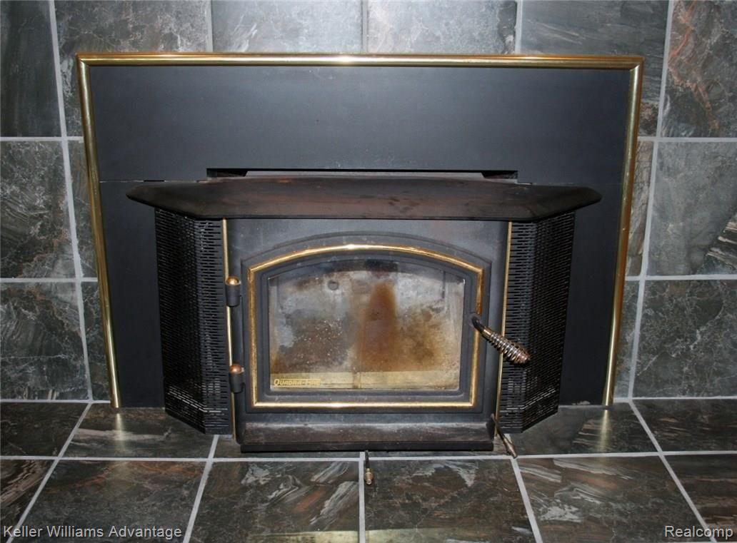 42477 Saltz Road Canton, MI 48187 - Photo 11 of 30 Wood-burning fireplace with newer tile surround