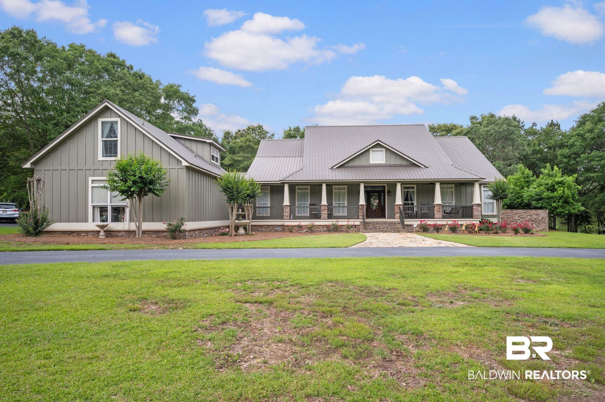 14591 Styx River Road Stapleton, AL 36578 - Photo 1 of 47 View of front of property with covered porch, a front yard, board and batten siding, and metal roof