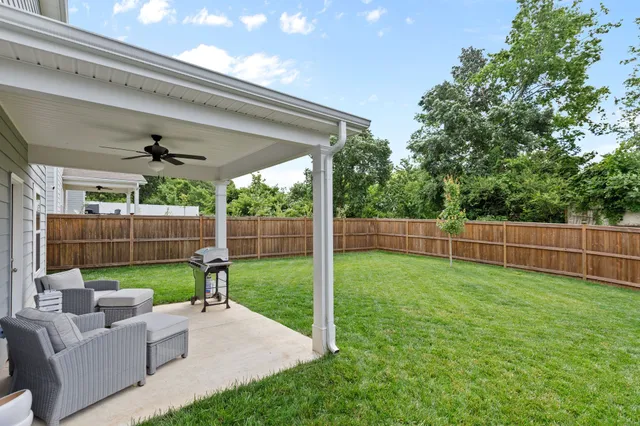 a view of a house with a yard and sitting area
