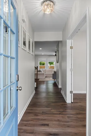a view of a hallway view with wooden floor and staircase
