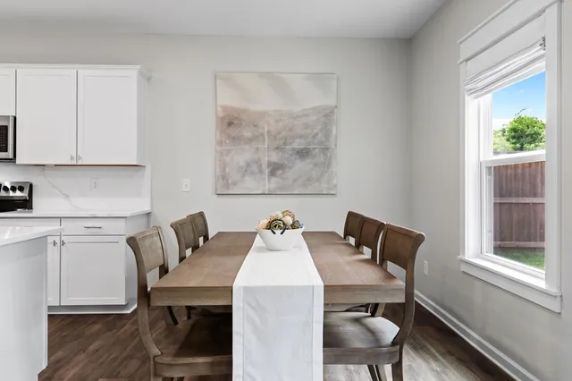 a view of a dining room with furniture and window