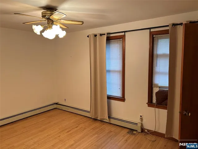 a view of a room with wooden floor