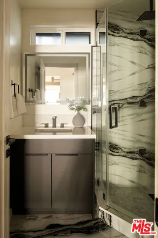 a bathroom with a shower and a sink