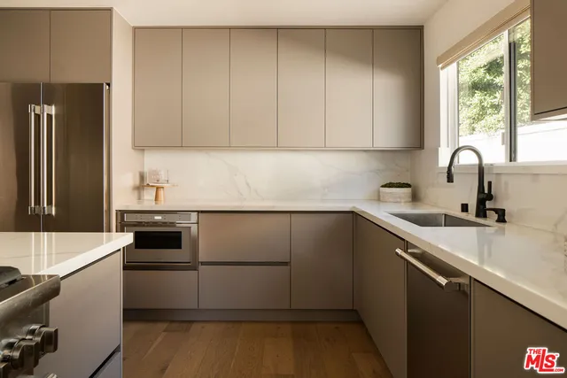 a kitchen with a sink stove and refrigerator
