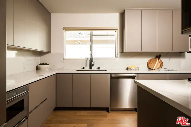 a kitchen with a sink cabinets and window