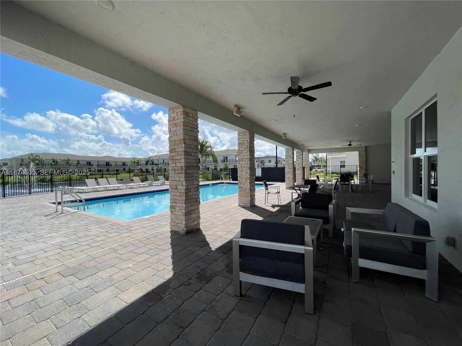 793 Southeast 19th Street Homestead, FL 33034 - Photo 12 of 13 a living room with patio furniture and a floor to ceiling window
