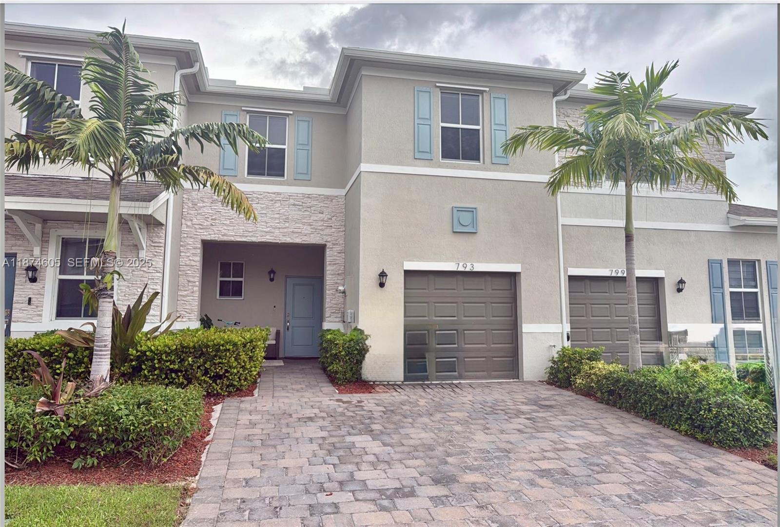 793 Southeast 19th Street Homestead, FL 33034 - Photo 2 of 13 a front view of a house with a yard and garage