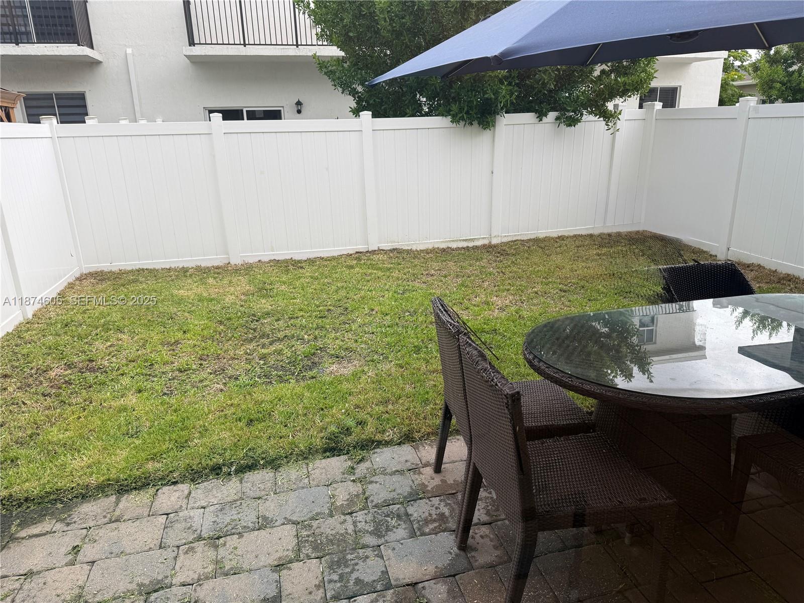 793 Southeast 19th Street Homestead, FL 33034 - Photo 4 of 13 a view of a backyard with table and chairs