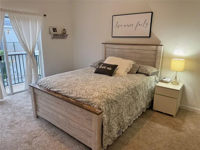 a bedroom with a bed and a night stand
