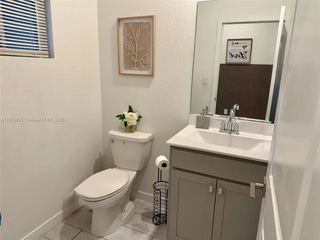 a bathroom with a sink mirror and toilet