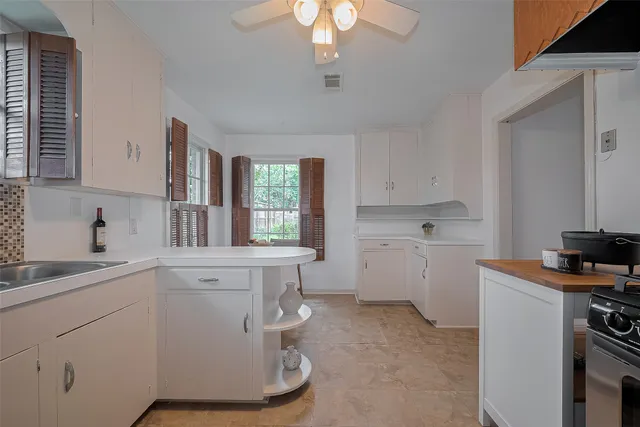 a kitchen with cabinets a sink and appliances