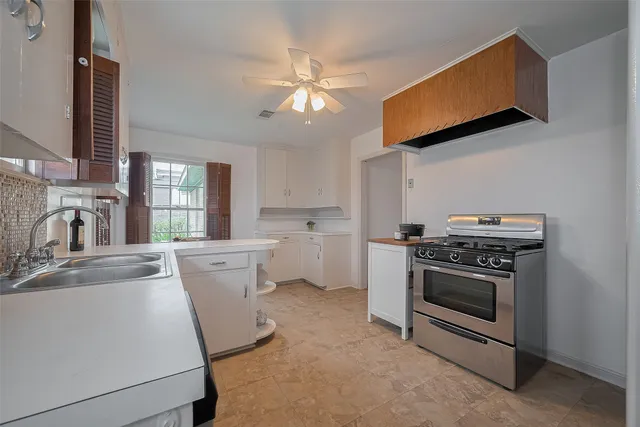a kitchen with a stove oven and sink