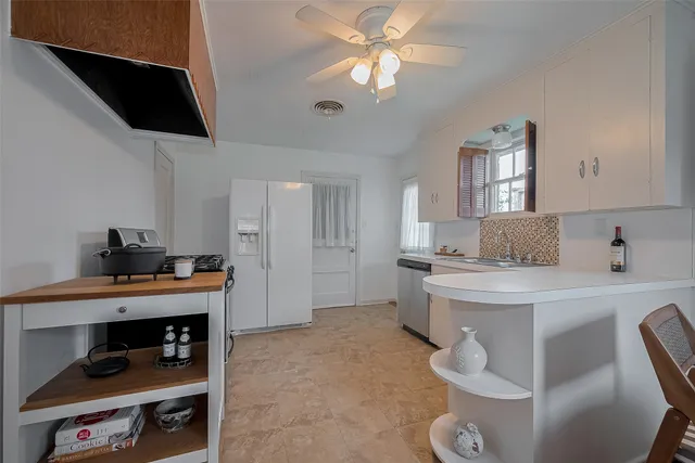 a kitchen with stainless steel appliances a stove a sink and a refrigerator